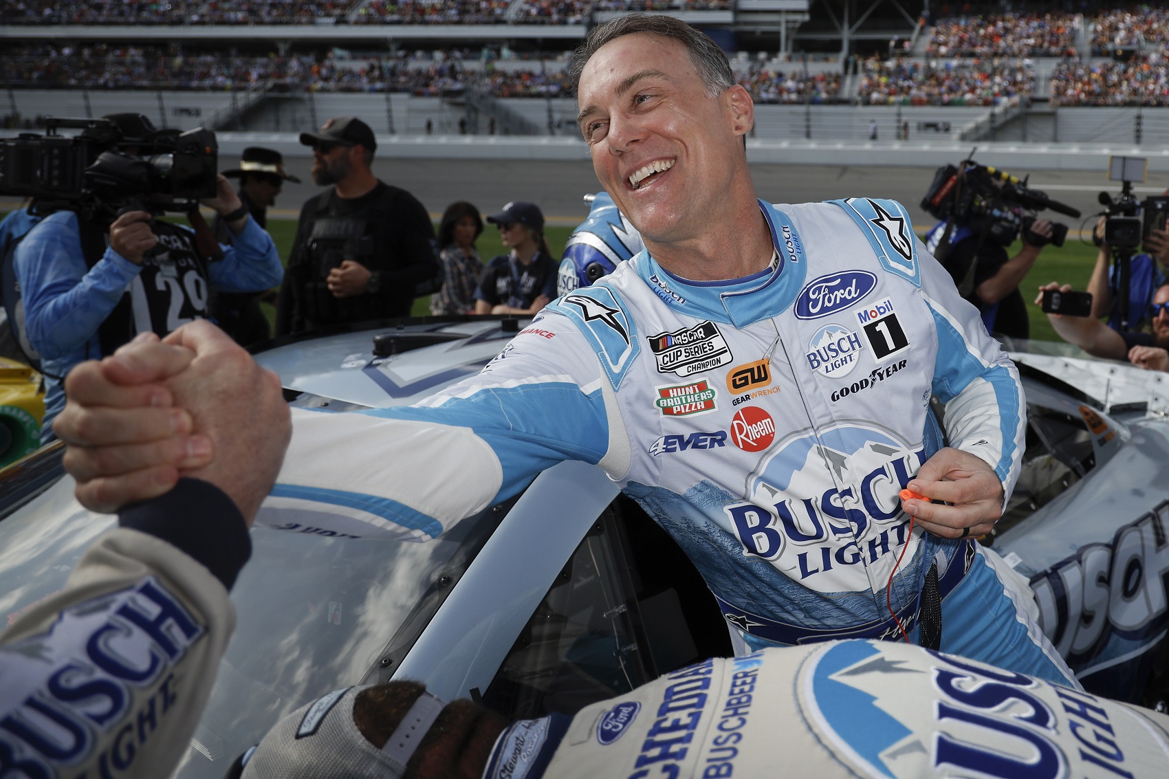DAYTONA BEACH, FLORIDA - FEBRUARY 19: Kevin Harvick, driver of the #4 Busch Light Ford, greets a crew member prior to the NASCAR Cup Series 65th Annual Daytona 500 at Daytona International Speedway on February 19, 2023 in Daytona Beach, Florida