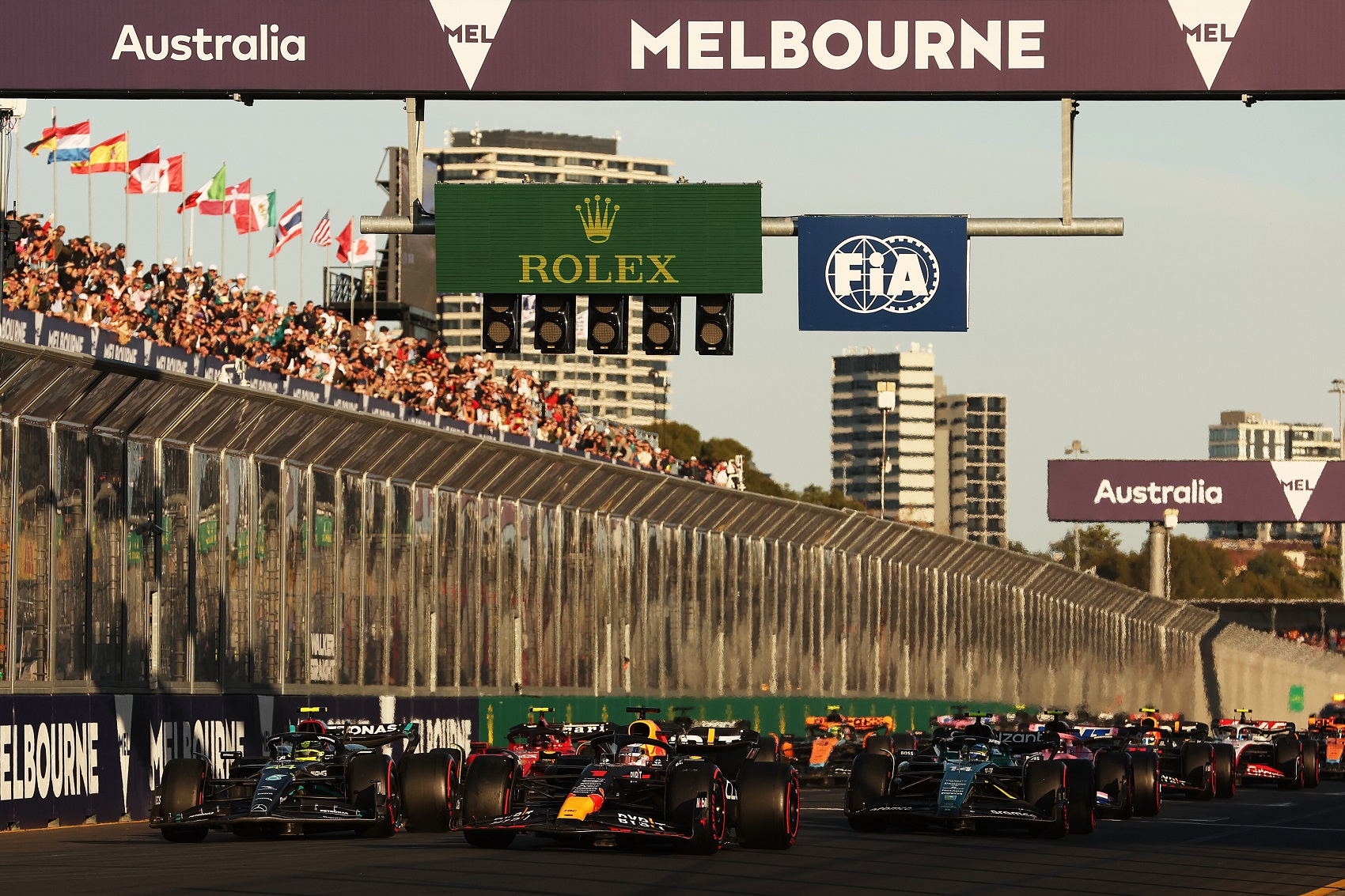 MELBOURNE, AUSTRALIA - APRIL 02: Race winner Max Verstappen of the Netherlands driving the (1) Oracle Red Bull Racing RB19 leads Second placed Lewis Hamilton of Great Britain driving the (44) Mercedes AMG Petronas F1 Team W14, Third placed Fernando Alonso of Spain driving the (14) Aston Martin AMR23 Mercedes and the rest of the field at the second restart during the F1 Grand Prix of Australia at Albert Park Grand Prix Circuit on April 02, 2023 in Melbourne, Australia
