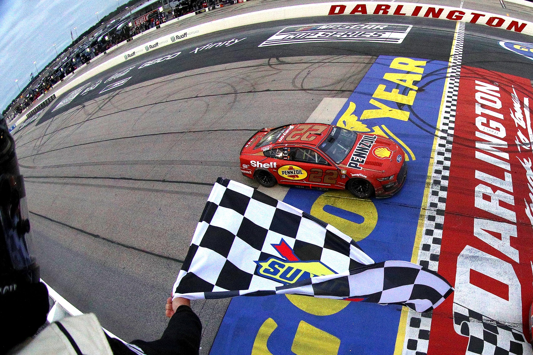 MAY 08: Joey Logano, driver of the #22 Shell Pennzoil Ford, takes the checkered flag to win the NASCAR Cup Series Goodyear 400 at Darlington Raceway on May 08, 2022 in Darlington, South Carolina.