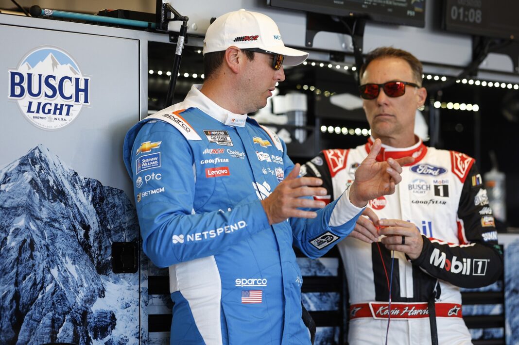 AUSTIN, TEXAS - MARCH 24: Kyle Busch, driver of the #8 Netspend Chevrolet, (L) and Kevin Harvick, driver of the #4 Mobil 1 Ford, talk in the garage area during practice for the NASCAR Cup Series EchoPark Automotive Grand Prix at Circuit of The Americas on March 24, 2023 in Austin, Texas
