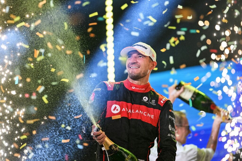 World Champion Jake Dennis, Avalanche Andretti Formula E, sprays champagne on the podium