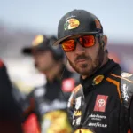 DARLINGTON, SOUTH CAROLINA - SEPTEMBER 02: Martin Truex Jr. Bass Pro Shops Toyota, driver of the #19 Joe Gibbs Racing, waits with his crew on the grid during qualifying for the NASCAR Cup Series Cook Out Southern 500 at Darlington Raceway on September 02, 2023 in Darlington, South Carolina