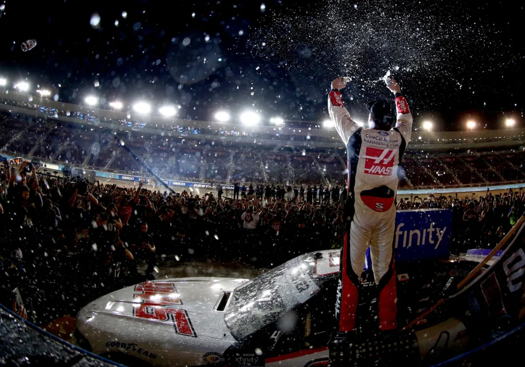 AVONDALE, ARIZONA - NOVEMBER 04: Cole Custer, driver of the #00 Haas Automation Ford, celebrates in victory lane after winning the NASCAR Xfinity Series Championship at Phoenix Raceway on November 04, 2023 in Avondale, Arizona